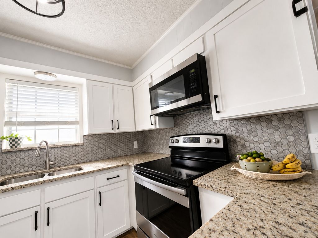 Close view of white Shaker cabinet doors surrounding a range