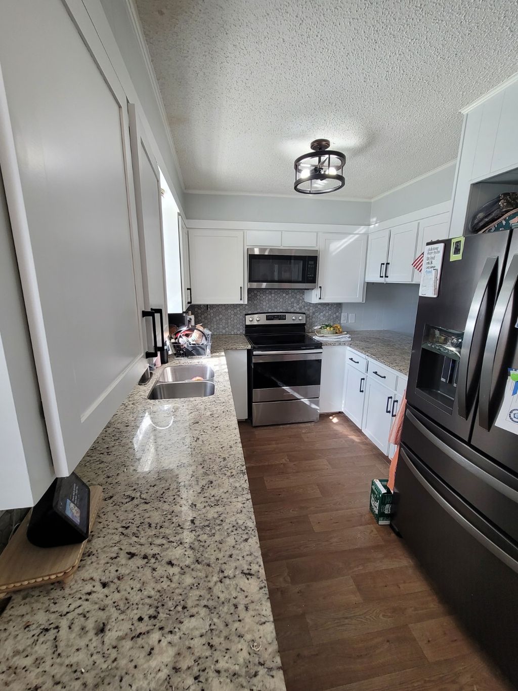 Wide view of a finished white cabinet kitchen