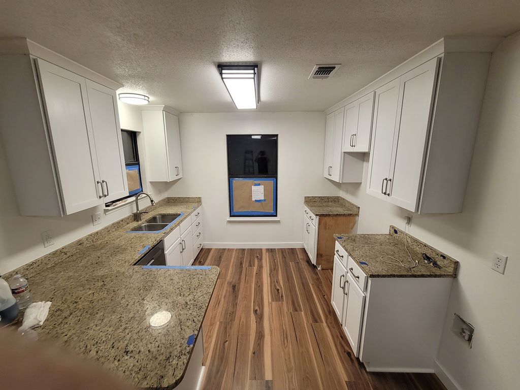 Finished kitchen with new white upper cabinets and refaced lowers